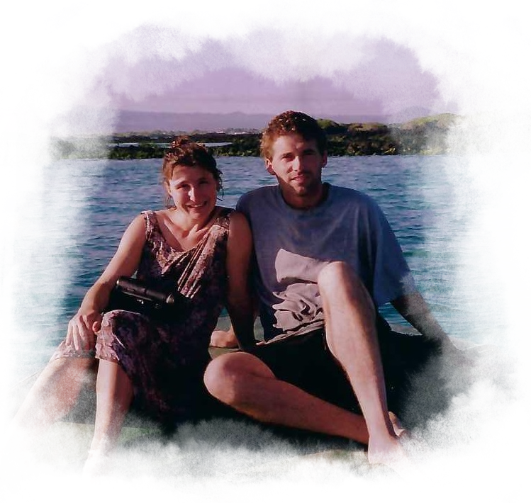 Marc and Heather, the owners of CNH tours, sitting together on a rock in the Galapagos.
