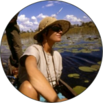 Image of Karen Ross looking out across the marshlands of the okavango in a canoe.